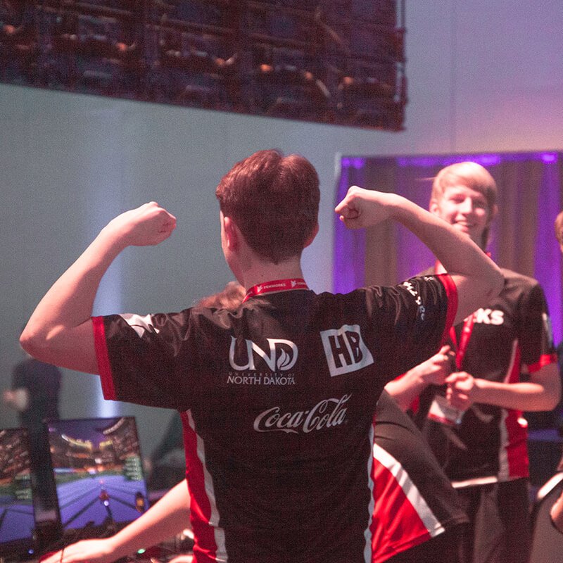 Young man flexing at esports tournament