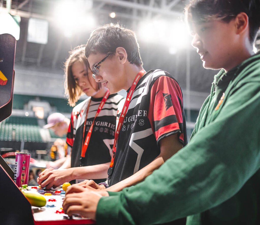 boys playing an arcade game
