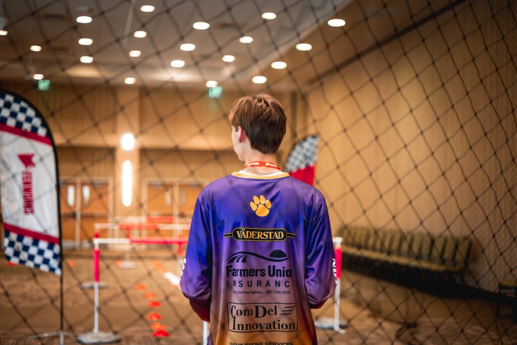 Wahpeton North Dakota student perfecting drone flight and maneuvering skills within the designated drone cage track course in preparation for the upcoming drone racing competition.